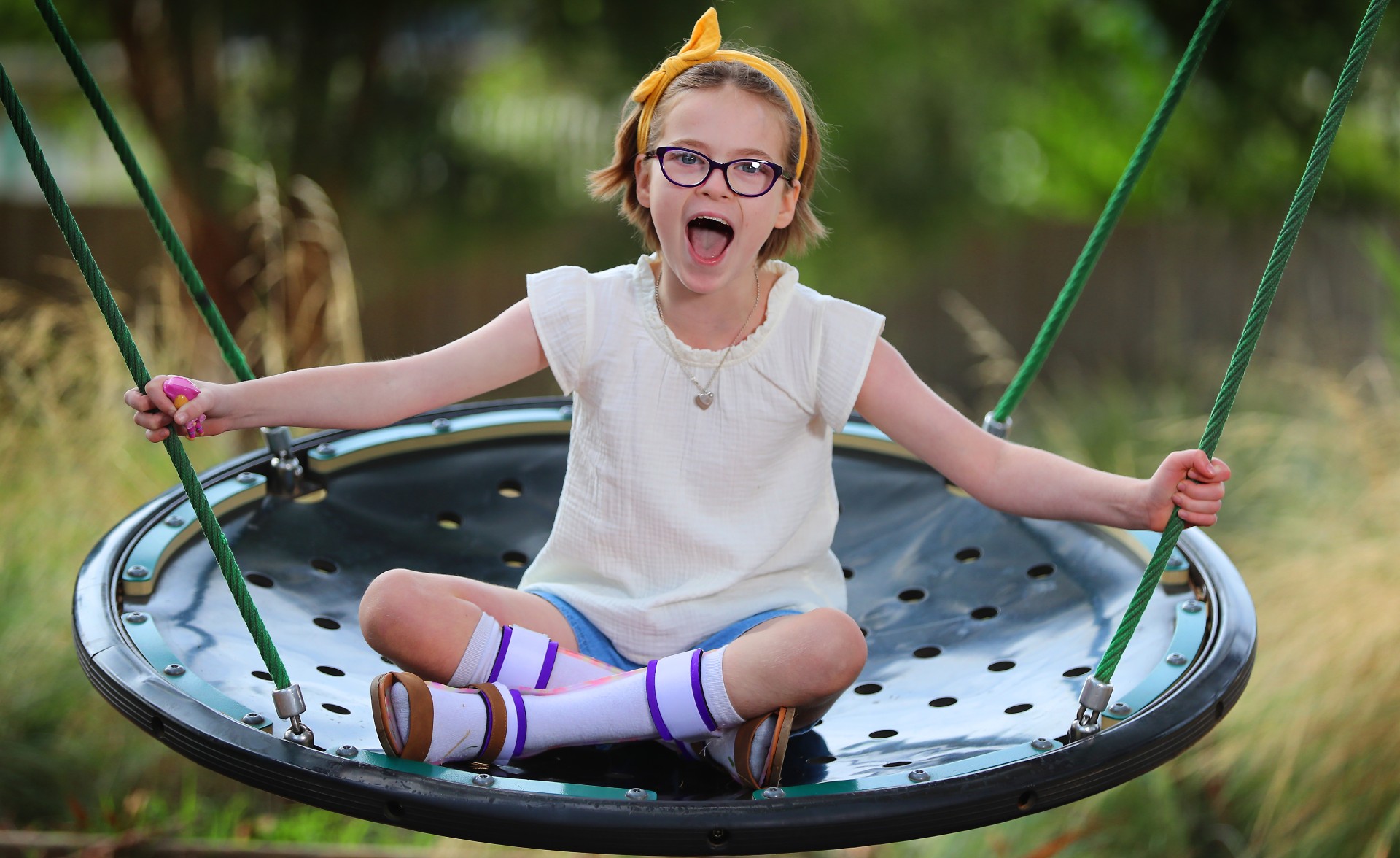 Matilda sitting on a swing