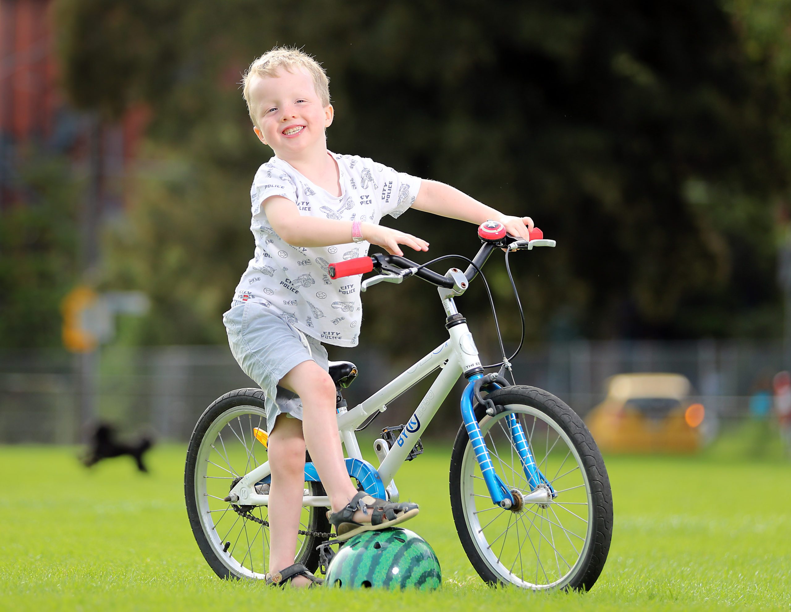 Jack sitting on his bike in a park