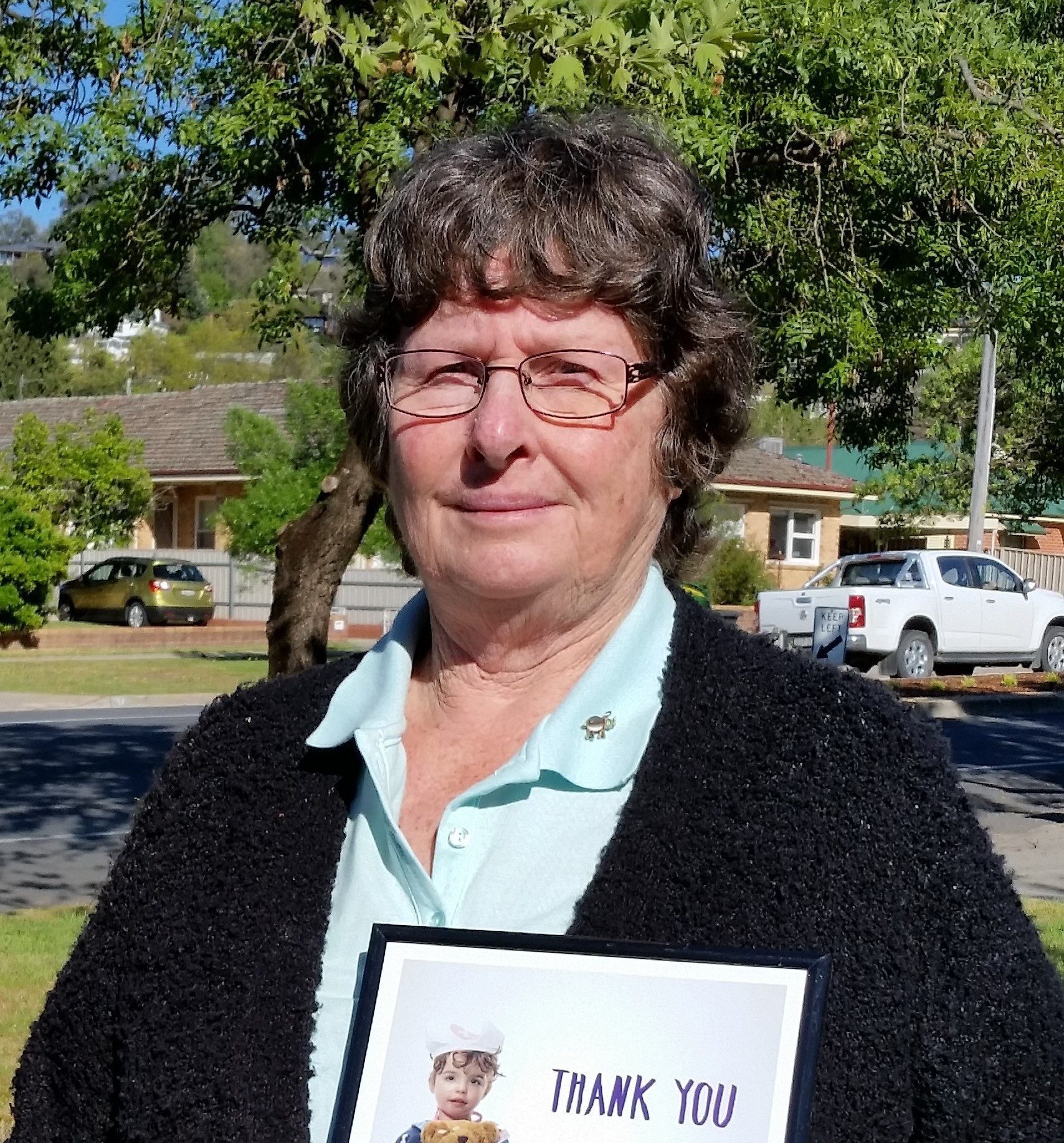 Kathie holding her Thank You certificate from the Good Friday Appeal