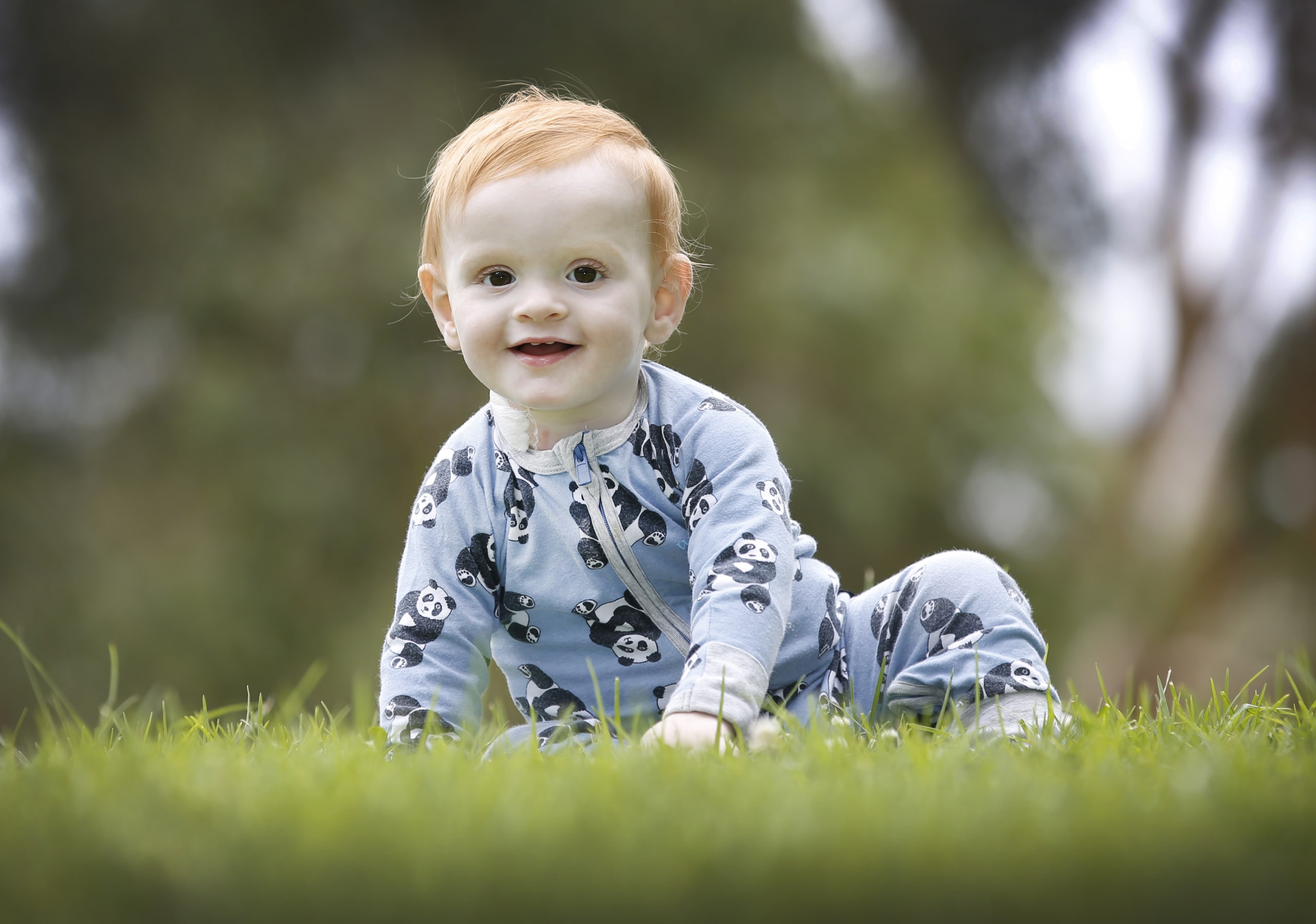 Samuel crawling on the grass