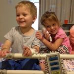 Tom and Tayla sitting on a hospital bed