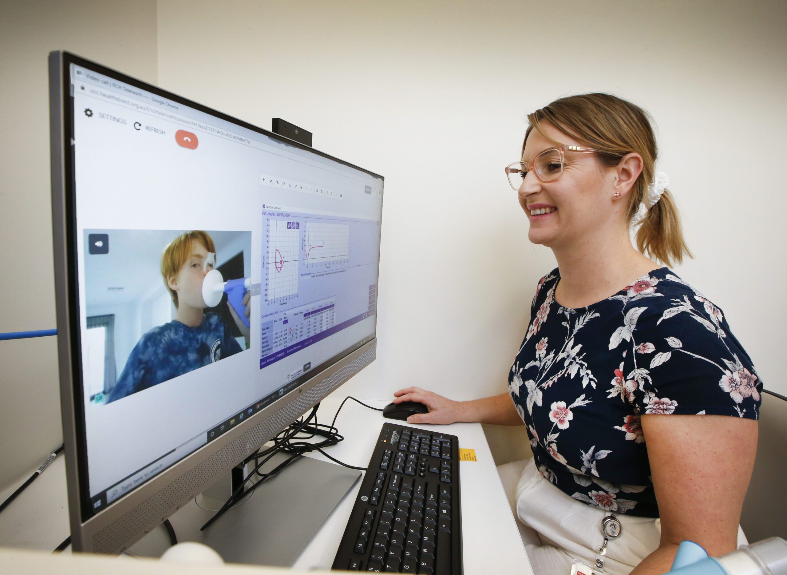Respiratory scientist monitoring patients through laptop