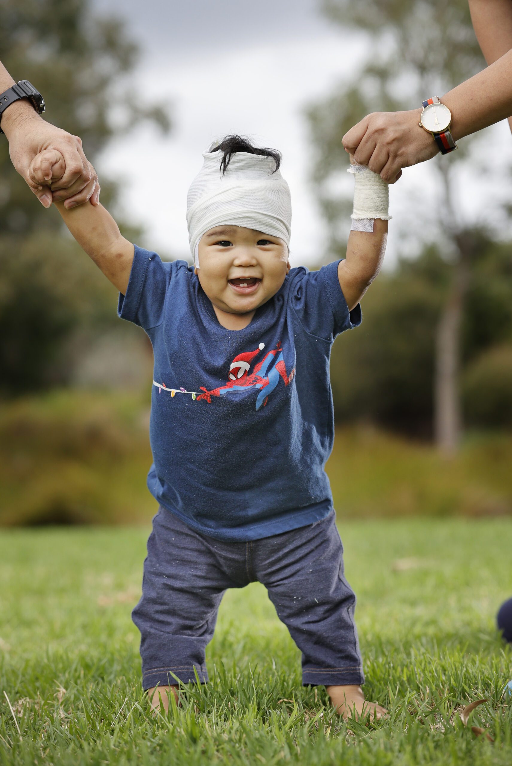 Little boy with a bandage on his head and wrist