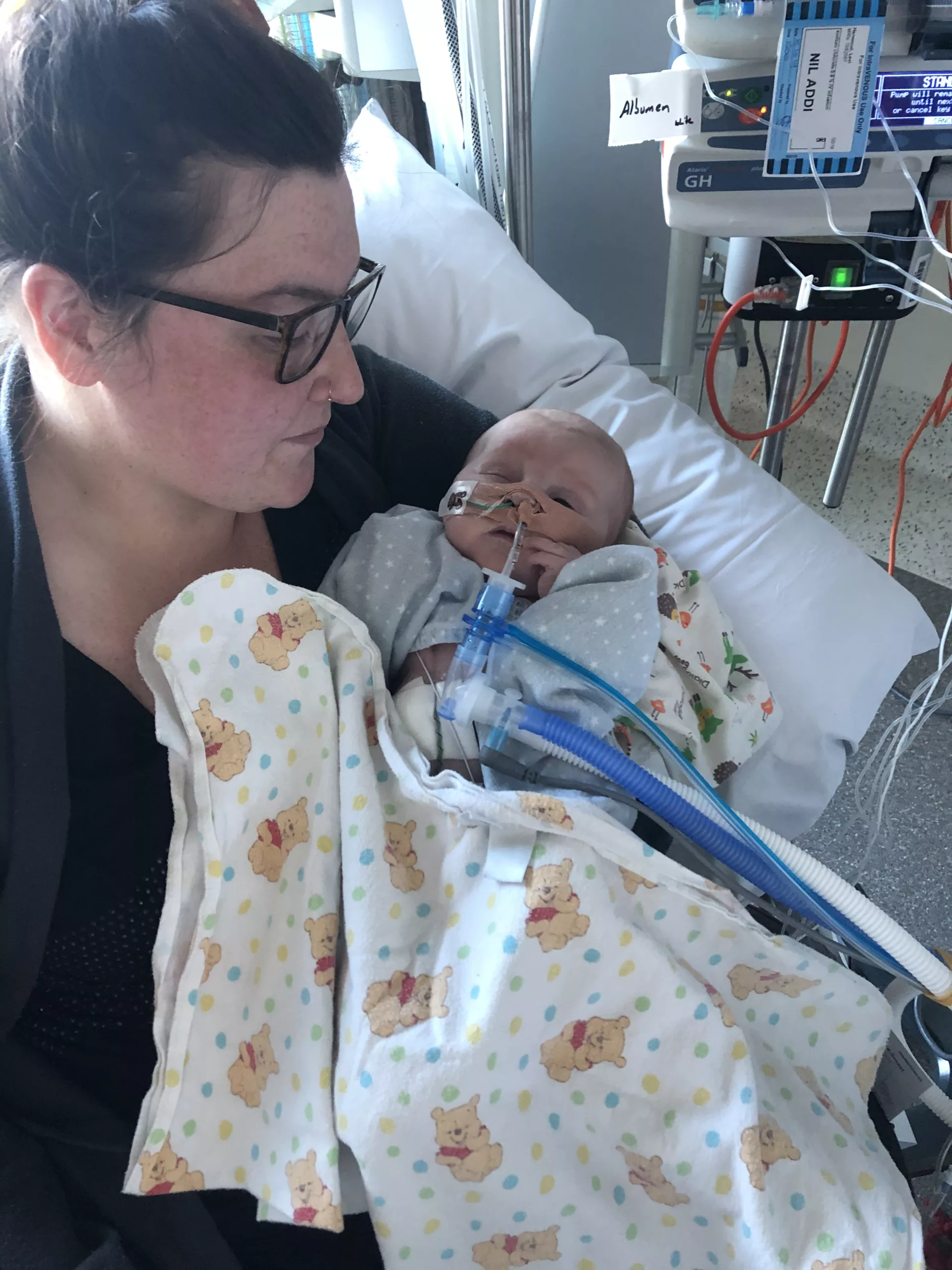Little Levi being held by his Mum in the hospital
