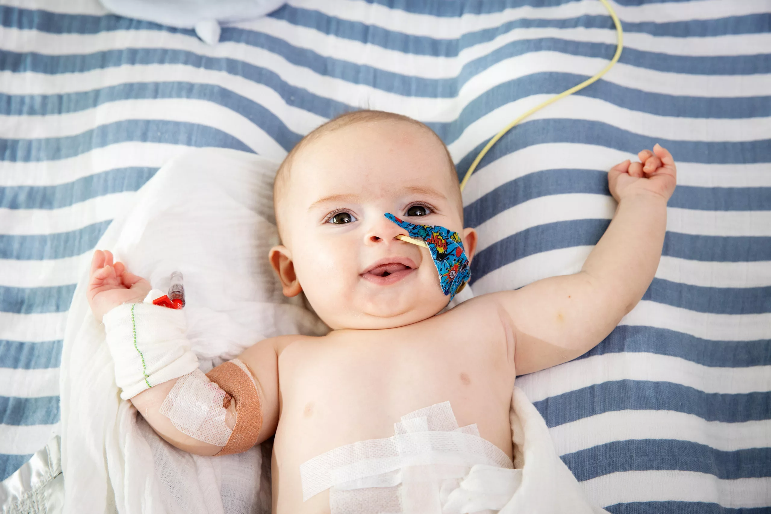 Brave baby Jax laying on a hospital bed