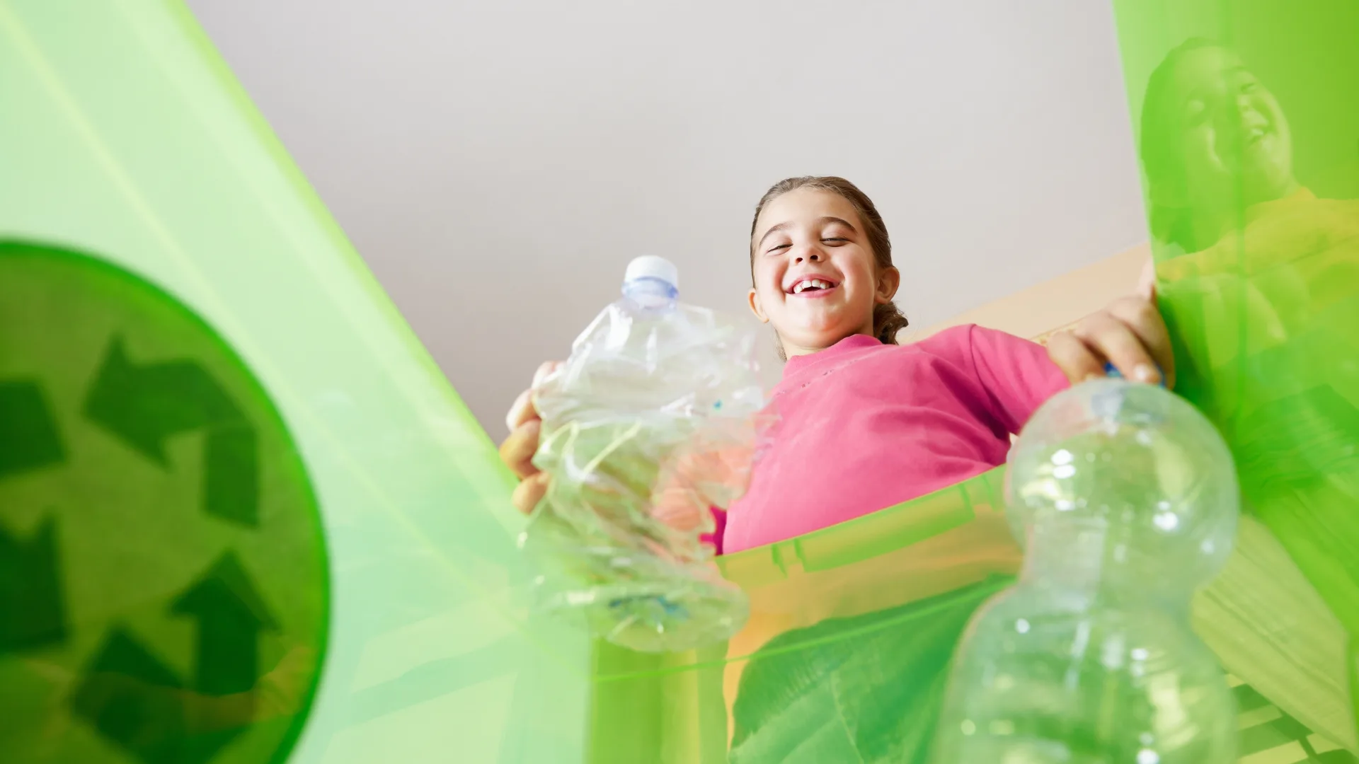Girl in pink shirt recycling plastic bottles for the CDS